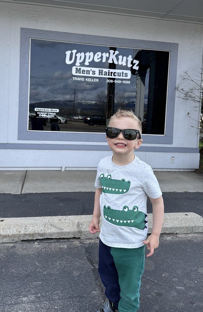 A happy young client outside the family-friendly UpperKutz