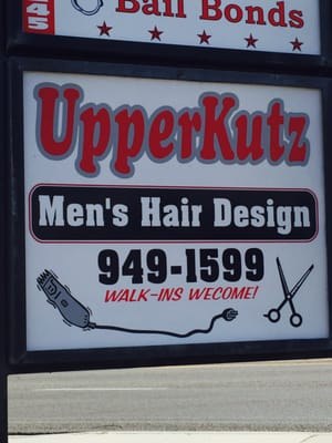 The UpperKutz Men's Hair Design street sign